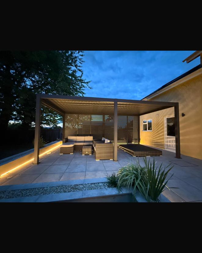 Warm LED feature lighting around a finished garden pergola and patio